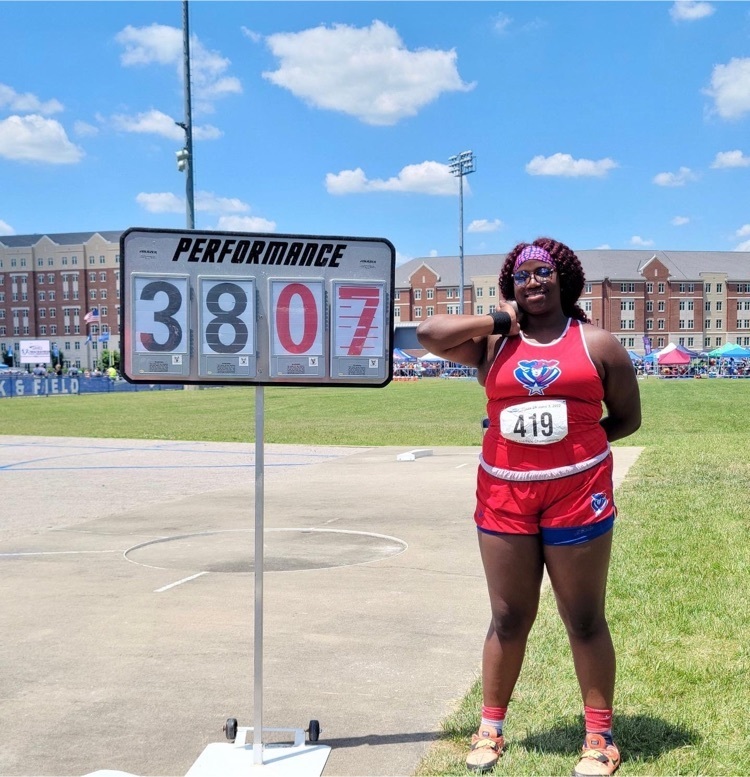 Germani Crosby posing next to 38-07.75 Her distance for Shot Put.