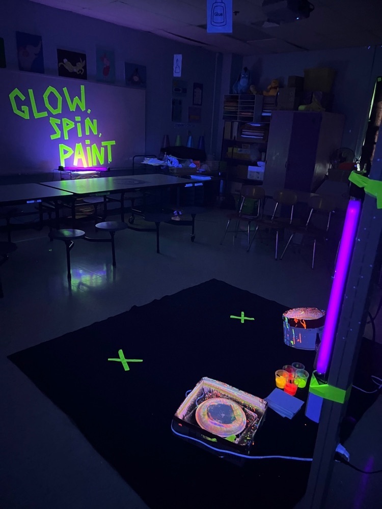 Glow, Spin , Paint in Green glow in the dark paint on a board.  Glowing objects in the room. 