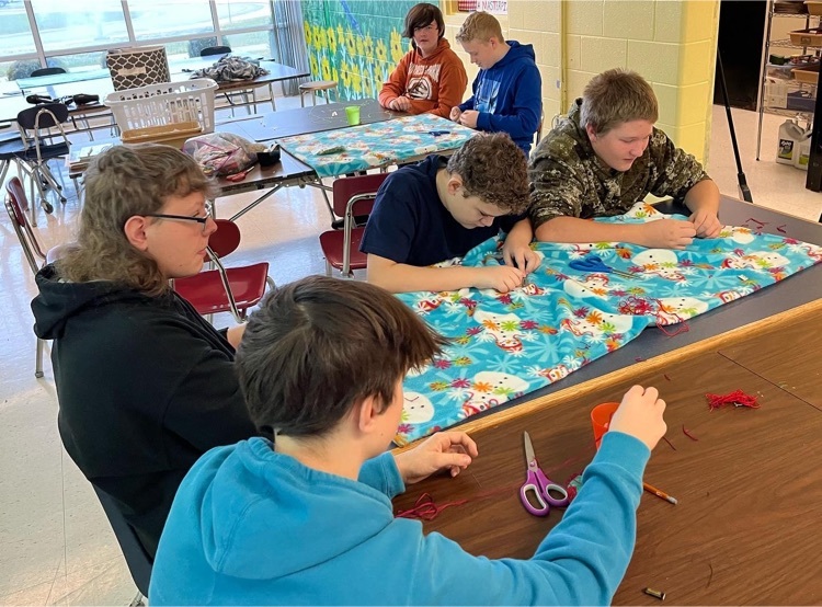 Students making quilts 