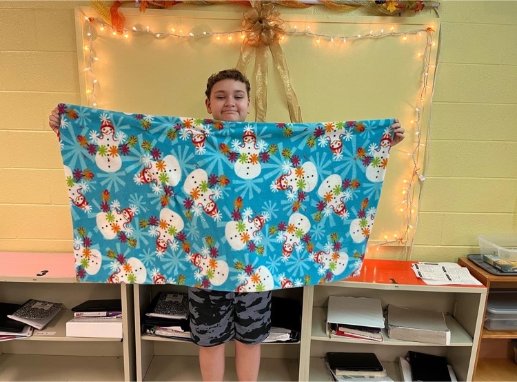 Student holding a quilt  